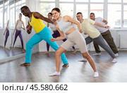 European girl with team of like-minded multinational people learn to elements of electro dance. Стоковое фото, фотограф Яков Филимонов / Фотобанк Лори