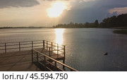 Picturesque sunset over the lake. Sunlight breaks through the clouds. Feeling of peace, inspiration and harmony with nature. Suitable for articles about travel, ecotourism, natural landscapes. Стоковое видео, видеограф Евгений Демидюк / Фотобанк Лори