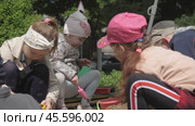 Children, boys and girls in kindergarten play in sand with toys on the street. Kids on the playground in sandbox on sunny day: Gomel, Belarus - June 2021. Редакционное видео, видеограф Дмитрий Нечаев / Фотобанк Лори