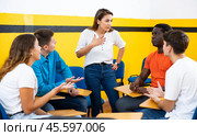 Portrait of delighted girl student with her groupmates and female teacher in auditorium. Стоковое фото, фотограф Яков Филимонов / Фотобанк Лори