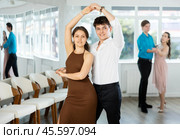 Latin American guy and girl performing kizomba in dance studio. Стоковое фото, фотограф Яков Филимонов / Фотобанк Лори