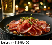 Thin slices of jamon. Jamon (in Spanish jamon - "ham") is a national dish of Spain, a dry-cured pork leg. Only the hind legs of the pig are used for jamon, which are dried whole. Enjoy your meal! Стоковое AI-изображение, AI-художник Сергей Елизарьев / Фотобанк Лори