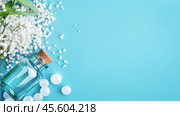 Homeopathic globules and a glass bottle rest on a pastel blue background, highlighting the essence of alternative medicine and healing herbs. The layout emphasizes clarity and wellness. Стоковое AI-изображение, AI-художник Sergey Grishin / Фотобанк Лори