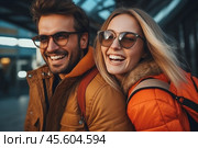 A cheerful couple shares a lighthearted moment in an urban setting, laughing and enjoying each other\'s company while wearing stylish jackets and sunglasses. Стоковое AI-изображение, AI-художник Sergey Grishin / Фотобанк Лори