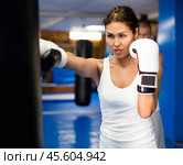 Asian woman training with punchbag. Стоковое фото, фотограф Яков Филимонов / Фотобанк Лори