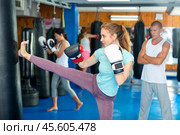 Woman kicking punchbag. Стоковое фото, фотограф Яков Филимонов / Фотобанк Лори
