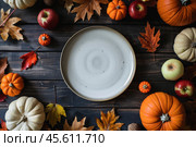 White plate on autumn background. Rustic menu mockup fall table setting decoration, colorful leaves. Floral interior decor for holidays with pumpkins. Thanksgiving dinner concept. Flatlay, top view. Стоковое AI-изображение, AI-художник Марина Демидюк / Фотобанк Лори