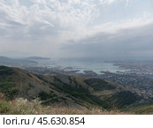 Panoramic view of Novorossiysk City and Tsemess Bay at sunrise. Morning cityscape of large port at Black Sea coast in Russia (2024 год). Стоковое фото, фотограф Фотограф / Фотобанк Лори