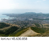 Panoramic view of Novorossiysk City and Tsemess Bay at sunrise. Morning cityscape of large port at Black Sea coast in Russia (2024 год). Стоковое фото, фотограф Фотограф / Фотобанк Лори