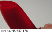 An exciting close-up shot allows you to see how the lipstick slides out of the tube. Стоковое видео, видеограф Ярославский Максим / Фотобанк Лори