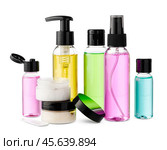 Variety of colorful personal care bottles and grooming accessories arranged on a white surface. Стоковое фото, фотограф Сергей Толмачёв / Фотобанк Лори