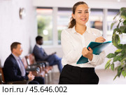 Happy young woman standing with her back to waiting room. Стоковое фото, фотограф Яков Филимонов / Фотобанк Лори