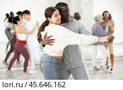Positive couple of dancers learns a slow foxtrot. Стоковое фото, фотограф Яков Филимонов / Фотобанк Лори