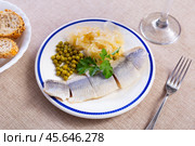 Slices of lightly salted herring filets with pickled cabbage, peas, greens. Стоковое фото, фотограф Яков Филимонов / Фотобанк Лори