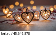 The concept of Valentine's Day, a banner with garlands in the form of hearts and magic lights for a holiday filled with love. A place for the text. Стоковое AI-изображение, AI-художник Photojuli / Фотобанк Лори