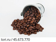Coffee beans spilling out of bucket. Стоковое фото, фотограф Александр Собко / Фотобанк Лори