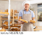 Elderly man seller with bocadillo in bakery. Стоковое фото, фотограф Яков Филимонов / Фотобанк Лори