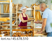Young female seller selling bocadillo to man buyer. Стоковое фото, фотограф Яков Филимонов / Фотобанк Лори