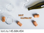 Dry January concept, empty glasses, bottles and corks on a gray background top view. Стоковое фото, фотограф Елена Руй / Фотобанк Лори