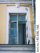 Open casement window in a wooden frame on the facade of an old building. Стоковое фото, фотограф Константин Григорьев / Фотобанк Лори