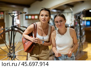 Woman and teenage girl looking at vintage bicycles in museum. Стоковое фото, фотограф Яков Филимонов / Фотобанк Лори
