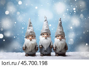 Three christmas gnomes standing in the snow while snowing. Стоковое AI-изображение, AI-художник Иван Рябоконь / Фотобанк Лори