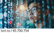 Young Asian male IT specialist looking at digital board with binary program code. Data analysis, matrix numbers and artificial intelligence technologies. Стоковое AI-видео, аниматор Александр Довянский / Фотобанк Лори