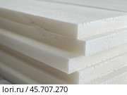 Stack of white polystyrene foam boards for construction. Стоковое AI-изображение, AI-художник Иван Рябоконь / Фотобанк Лори