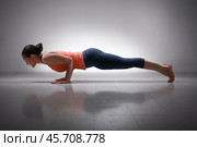 Woman practices yoga asana Chaturanga Dandasana. Стоковое фото, фотограф Дмитрий Рухленко / Фотобанк Лори