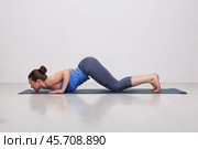 Sporty fit yogini woman practices yoga asana Ashtangasana. Стоковое фото, фотограф Дмитрий Рухленко / Фотобанк Лори