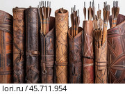 Collection of traditional leather quivers holding arrows. Стоковое AI-изображение, AI-художник Иван Рябоконь / Фотобанк Лори
