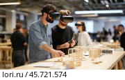 Designers use virtual reality tools to create woodworking prototypes in a modern workspace. Стоковое AI-изображение, AI-художник Сергей Толмачёв / Фотобанк Лори