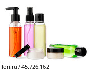 Variety of colorful personal care bottles and grooming accessories arranged on a white surface. Стоковое фото, фотограф Сергей Толмачёв / Фотобанк Лори
