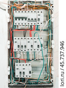 Circuit breakers with wiring in electrical cabinet in typical apartments. Electrical distribution board with wires and Common trip breakers, mounted in wall. Стоковое фото, фотограф Константин Григорьев / Фотобанк Лори