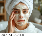 Spa treatments for the face, peeling face mask, skin care. Young woman with cream mask on her face. Close-up. Стоковое AI-изображение, AI-художник Сергей Елизарьев / Фотобанк Лори