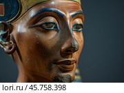 Tutankhamun's funeral mask closeup showing serene expression and golden stripes. Стоковое AI-изображение, AI-художник Иван Рябоконь / Фотобанк Лори