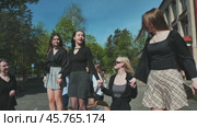 Happy high school students dancing and rejoicing in front of their school as the school day ends. Стоковое видео, видеограф Mikhail Davidovich / Фотобанк Лори