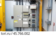 Electrical distribution board showing fuses, wiring, and circuit breakers. Стоковое AI-изображение, AI-художник Юрий Поздников / Фотобанк Лори