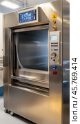 Modern pass through autoclave sterilizing medical instruments in hospital setting. Стоковое AI-изображение, AI-художник Юрий Поздников / Фотобанк Лори