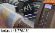 Modern Digital Large format UV printer. Printing production technologies. UV pinning is the process of applying a dose of low intensity ultraviolet light to a UV curable ink. Стоковое видео, видеограф Андрей Армягов / Фотобанк Лори
