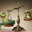The symbol of 2025, the green snake, and the symbol of the outgoing 2024, the dragon, on old vintage scales find out who is more important. Стоковое AI-изображение, AI-художник Сергей Комаров / Фотобанк Лори