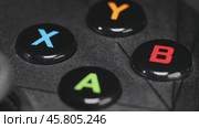 Modern gamepad on a dark. Game controller close-up. Стоковое видео, видеограф Андрей Армягов / Фотобанк Лори