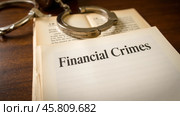 Handcuffs on open book showing financial crimes, depicting fraud, corruption, white-collar crime, law enforcement, legal issues, finance, investigation. Стоковое AI-изображение, AI-художник Павел Муравьев / Фотобанк Лори