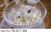 Whole grain cereal muesli in a bowl for a morning delicious breakfast with milk. Slow motion with rotation tracking shot. Стоковое видео, видеограф Андрей Армягов / Фотобанк Лори