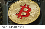 Gold Bit Coin BTC coins on the motherboard. Bitcoin is a worldwide cryptocurrency and digital payment system called the first decentralized digital currency. Стоковое видео, видеограф Андрей Армягов / Фотобанк Лори