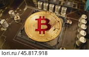 Gold Bit Coin BTC coins on the motherboard. Bitcoin is a worldwide cryptocurrency and digital payment system called the first decentralized digital currency. Стоковое видео, видеограф Андрей Армягов / Фотобанк Лори