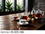 Collection of variety ceylon teas on wooden table in meeting room at manufacturing plant on tea factory, still life. Demonstration perfect tea set, close-up. Tea production concept. Copy ad text space. Стоковое AI-изображение, AI-художник Aleksandr Golubev / Фотобанк Лори