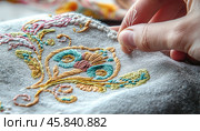 Close up of embroiderer hands stitching floral design on fabric. Стоковое AI-изображение, AI-художник Юрий Поздников / Фотобанк Лори