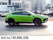 Lamborghini Urus green color sports car drive on city street. Редакционное фото, фотограф Константин Григорьев / Фотобанк Лори