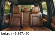 Stylish Interior of SUV, Luxury Seating. Elegant large powerful sports SUV, premium quality brown beige leather seats. Car rear seats. New modern car inside. Lease, rental car, sell, buy. Loan credit. Стоковое AI-видео, аниматор Марина Демидюк / Фотобанк Лори
